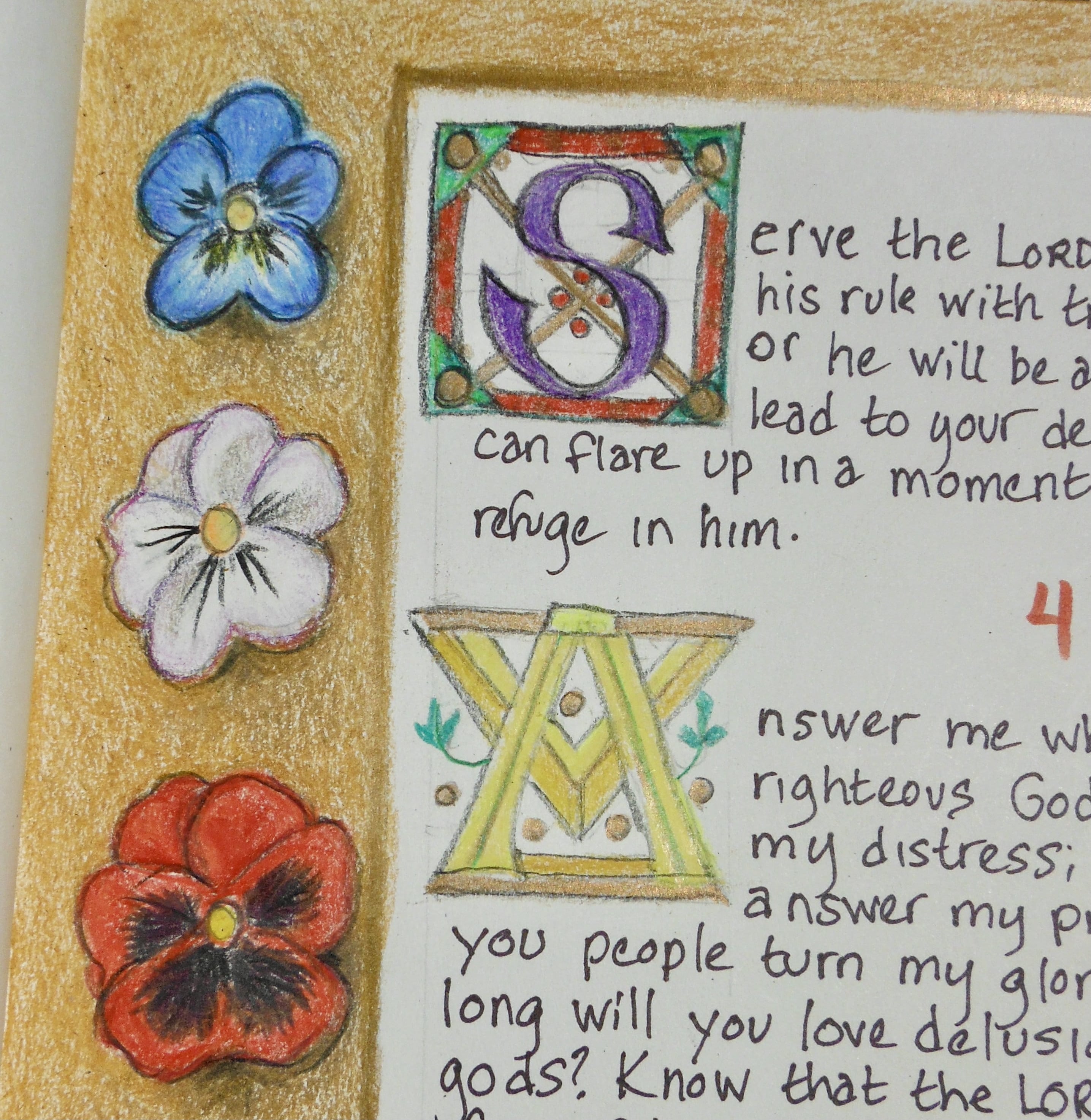 Initials and a border in a homemade book inspired by medieval manuscripts.